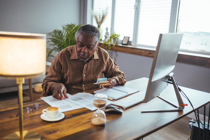 Man at his desk decreasing his Social Security & Medicare Taxes
