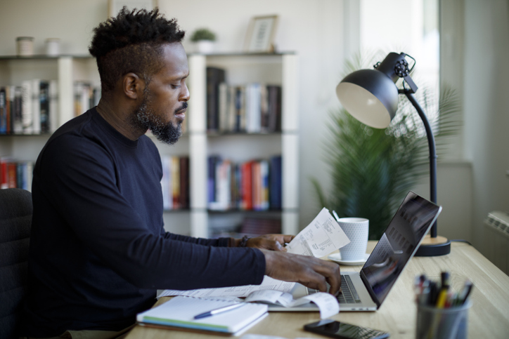 A man at his desk learning about 2024 business tax deduction strategies