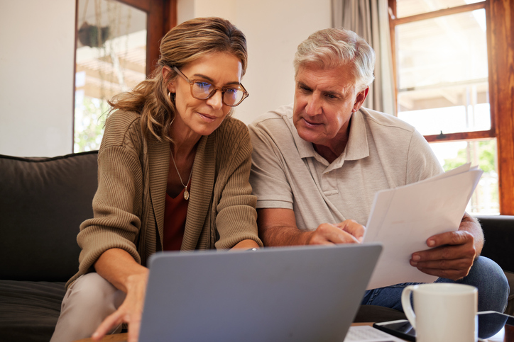 A couple on a couch going over 2024 Retirement Deductions