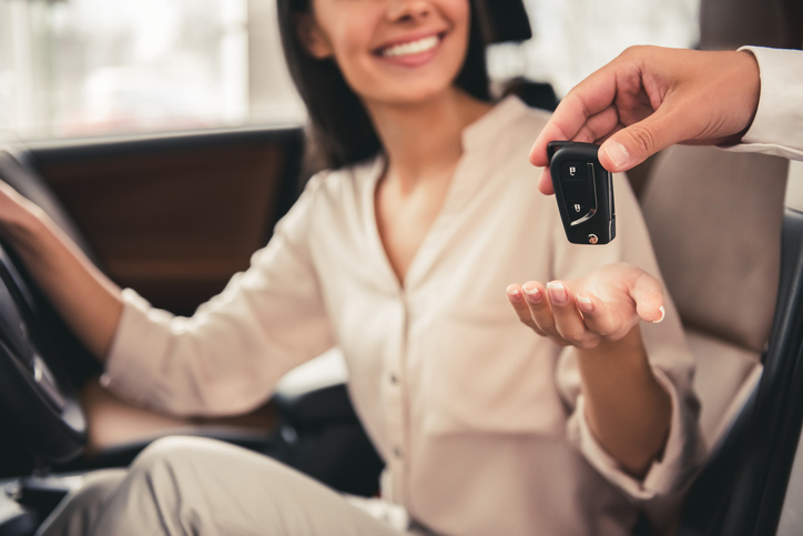 A smiling woman looking forward to tax deductions for her business's existing vehicles